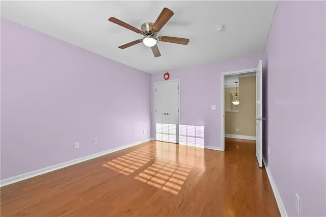 a view of a livingroom with a ceiling fan and window