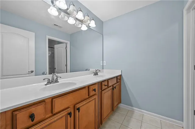 a bathroom with a glass shower door and a mirror