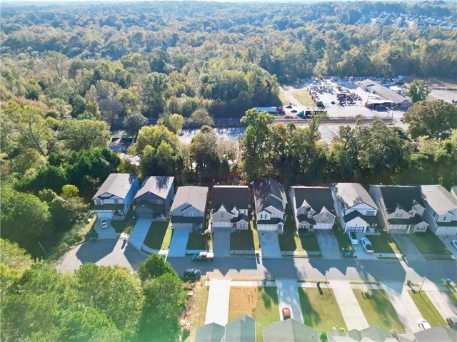 an aerial view of a house with yard swimming pool and ocean view