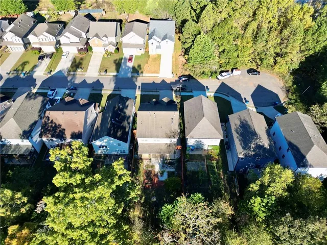 an aerial view of multiple houses with yard