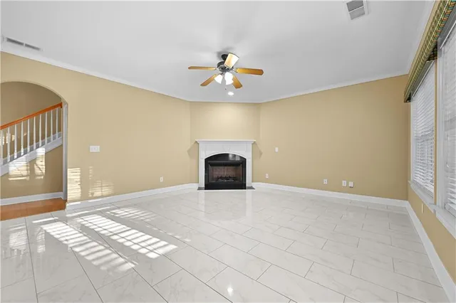a view of entryway and hall with chandelier fan