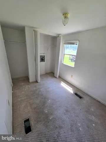 a view of work space with furniture and windows