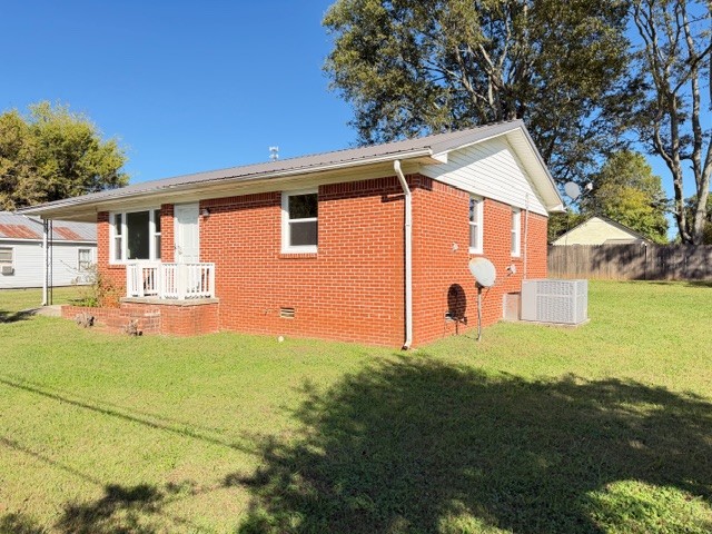 128 Stewart Street Cowan, TN 37318 - Photo 2 of 14 a front view of a house with yard and outdoor seating
