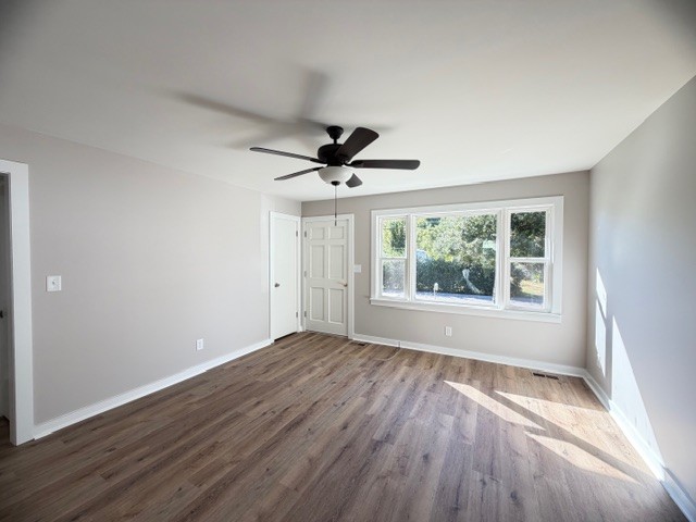 128 Stewart Street Cowan, TN 37318 - Photo 4 of 14 a view of empty room with wooden floor and fan