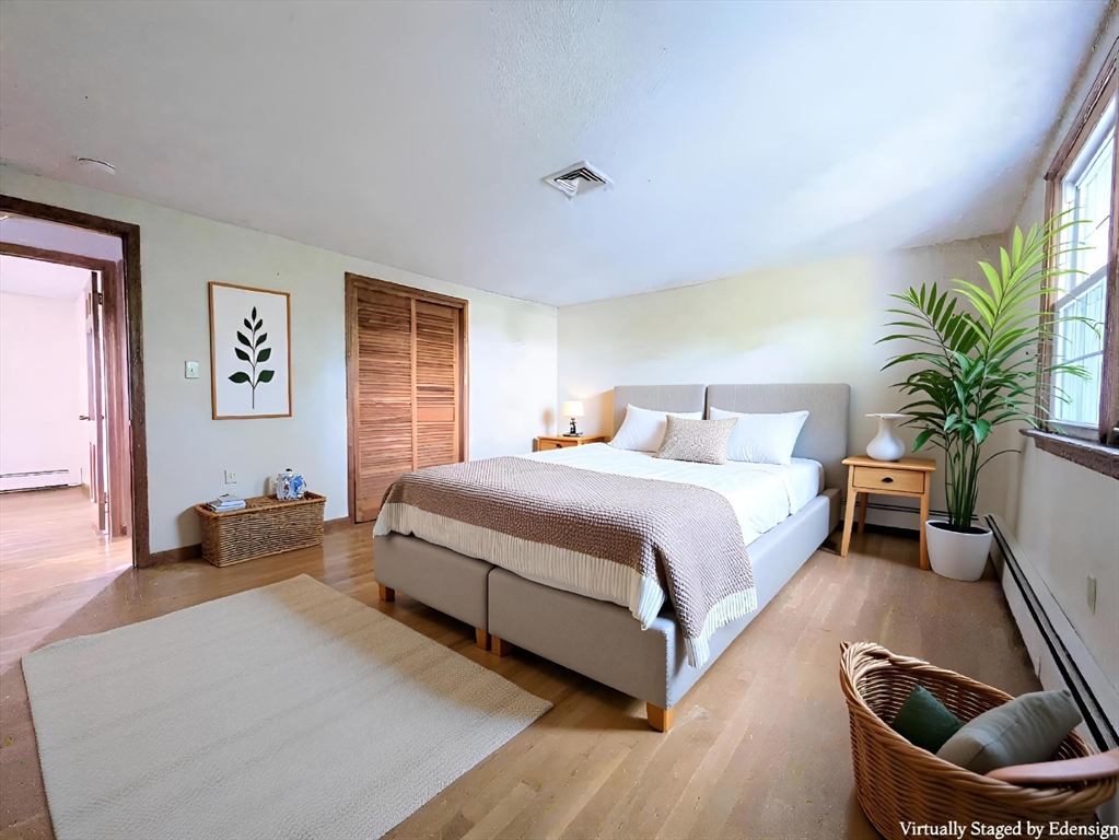 34 Leeds Terrace Lawrence, MA 01843 - Photo 11 of 27 a spacious bedroom with a bed a couch and potted plant