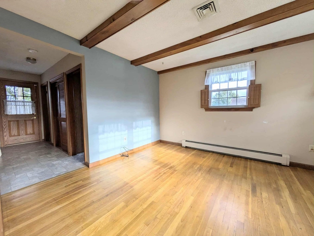 34 Leeds Terrace Lawrence, MA 01843 - Photo 14 of 27 a view of an empty room with wooden floor and a window