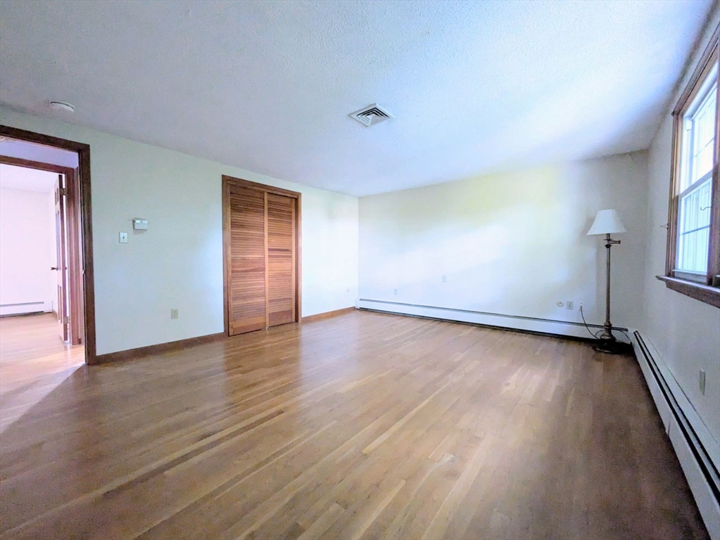 34 Leeds Terrace Lawrence, MA 01843 - Photo 20 of 27 an empty room with wooden floor and windows