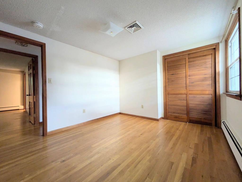 34 Leeds Terrace Lawrence, MA 01843 - Photo 21 of 27 a view of an empty room with wooden floor and a window