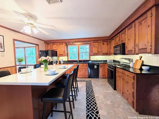 a large kitchen with lots of counter space a sink and cabinets