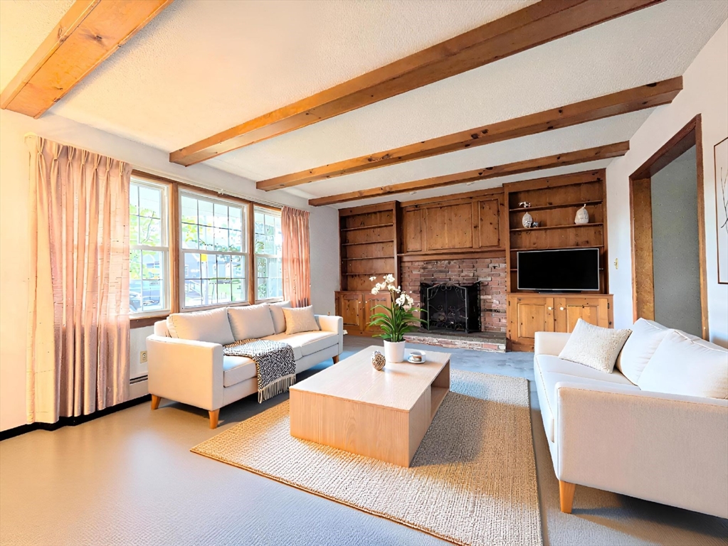 34 Leeds Terrace Lawrence, MA 01843 - Photo 6 of 27 a living room with furniture fireplace and a flat screen tv