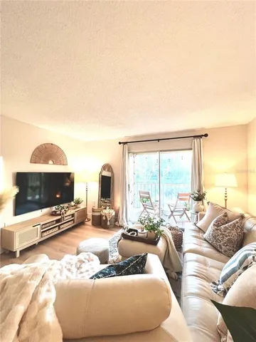 a living room with furniture and a mirror