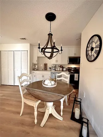 a kitchen with a table chairs a sink and dishwasher
