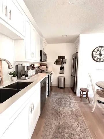 a kitchen with a sink and a stove top oven