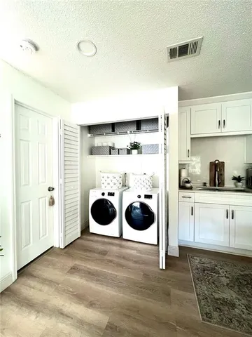 a bedroom with bed and painting on the wall