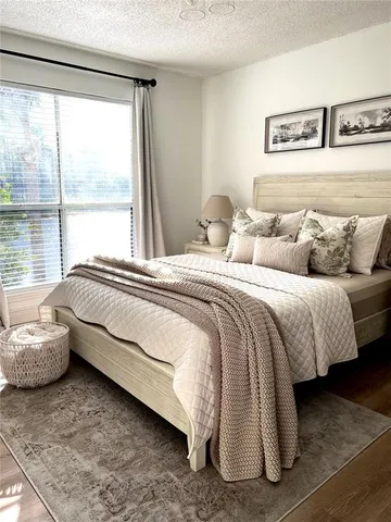 a bathroom with a sink a mirror a toilet and a window