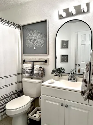 a bathroom with a toilet a sink and a mirror