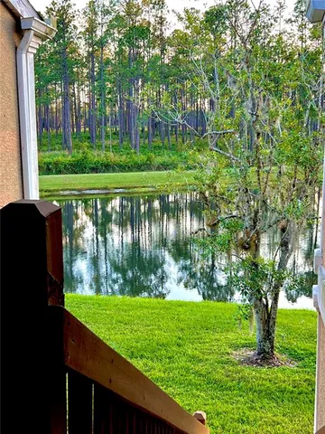 a view of yard with swimming pool and green space