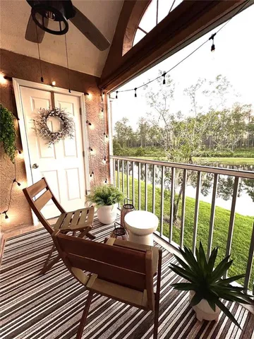 a view of a balcony with chairs and wooden floor
