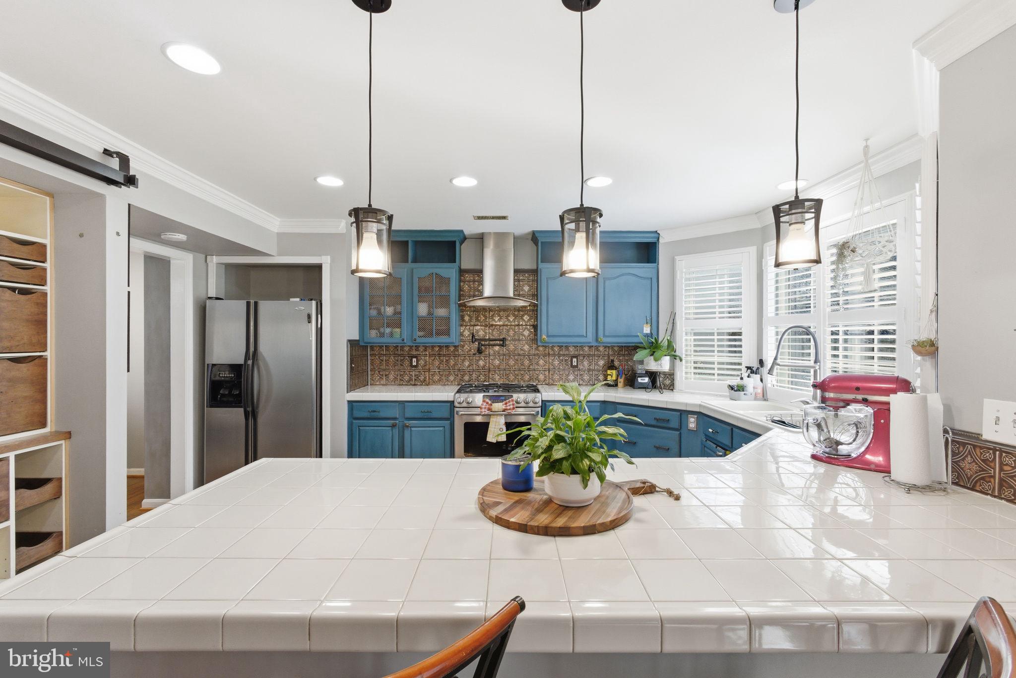 44913 Widgeon Place Callaway, MD 20620 - Photo 14 of 49 a kitchen with a refrigerator a oven and white cabinets