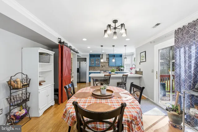 a view of a dining room with furniture and chandelier