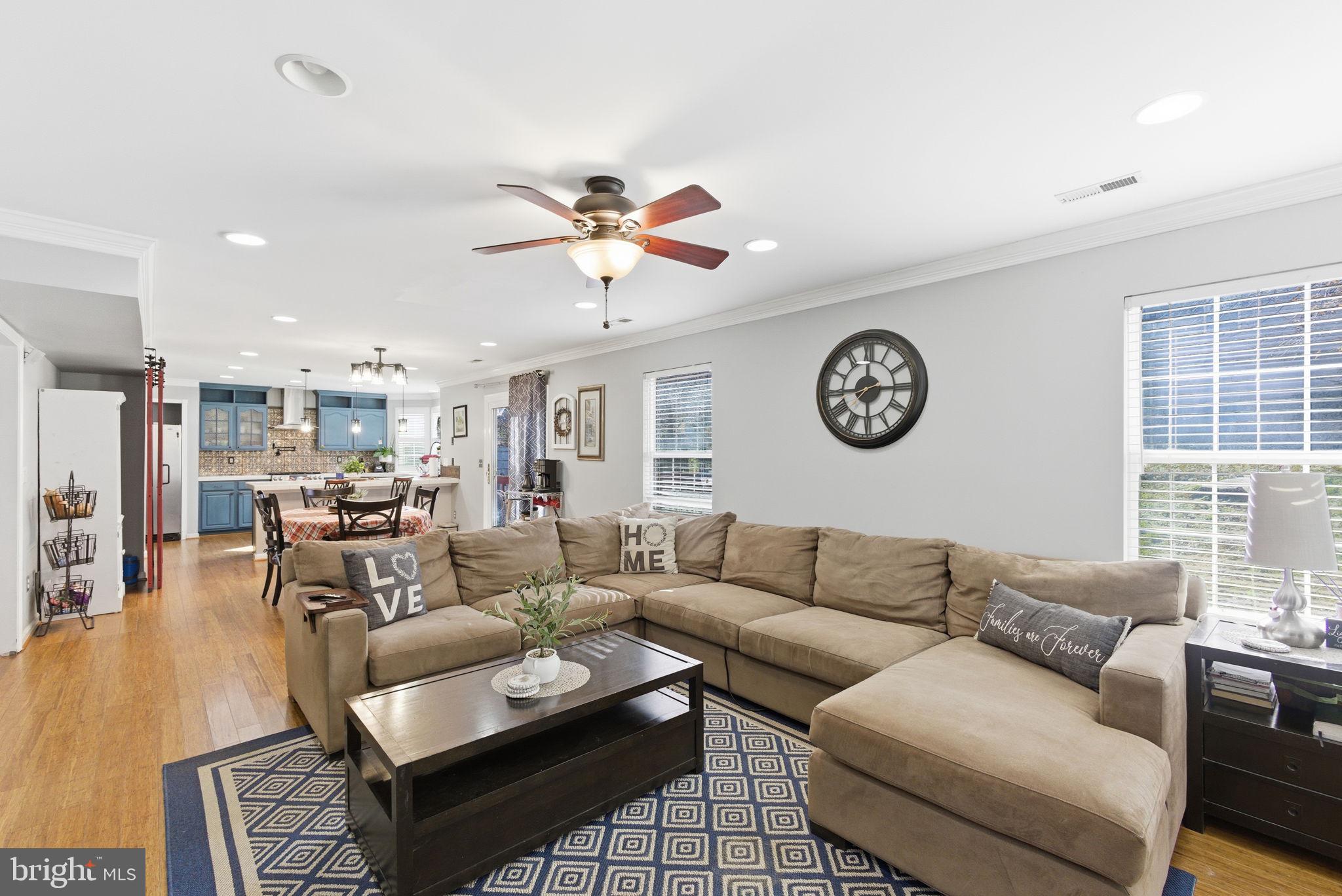 44913 Widgeon Place Callaway, MD 20620 - Photo 19 of 49 a living room with furniture a clock on wall and a window
