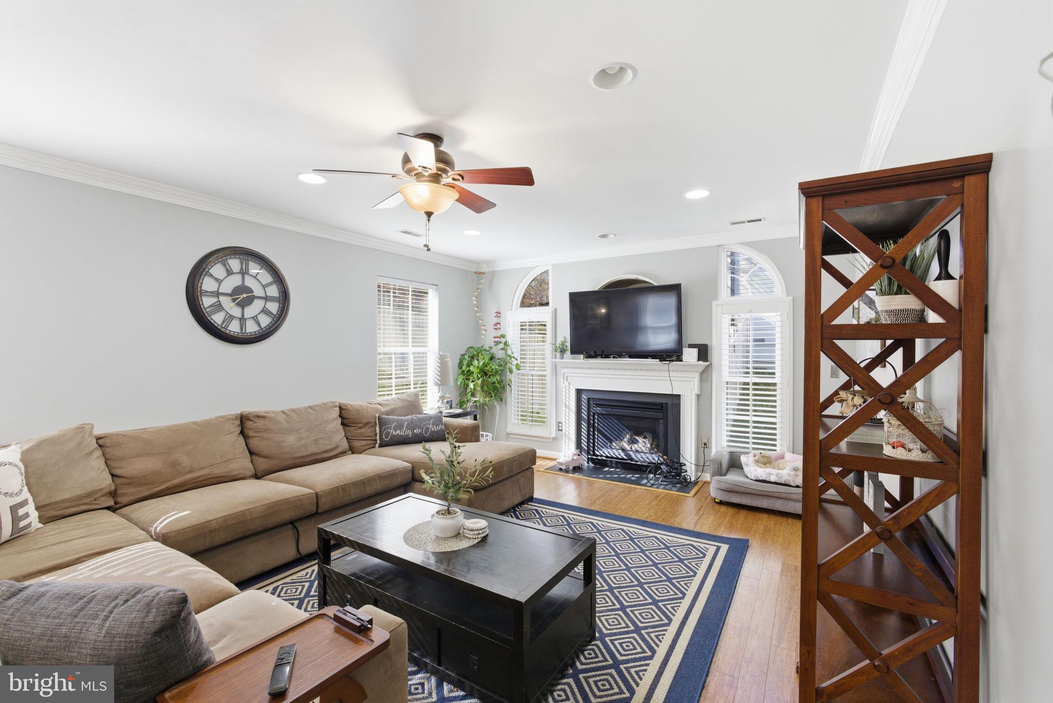44913 Widgeon Place Callaway, MD 20620 - Photo 20 of 49 a living room with furniture a clock on wall and a fireplace