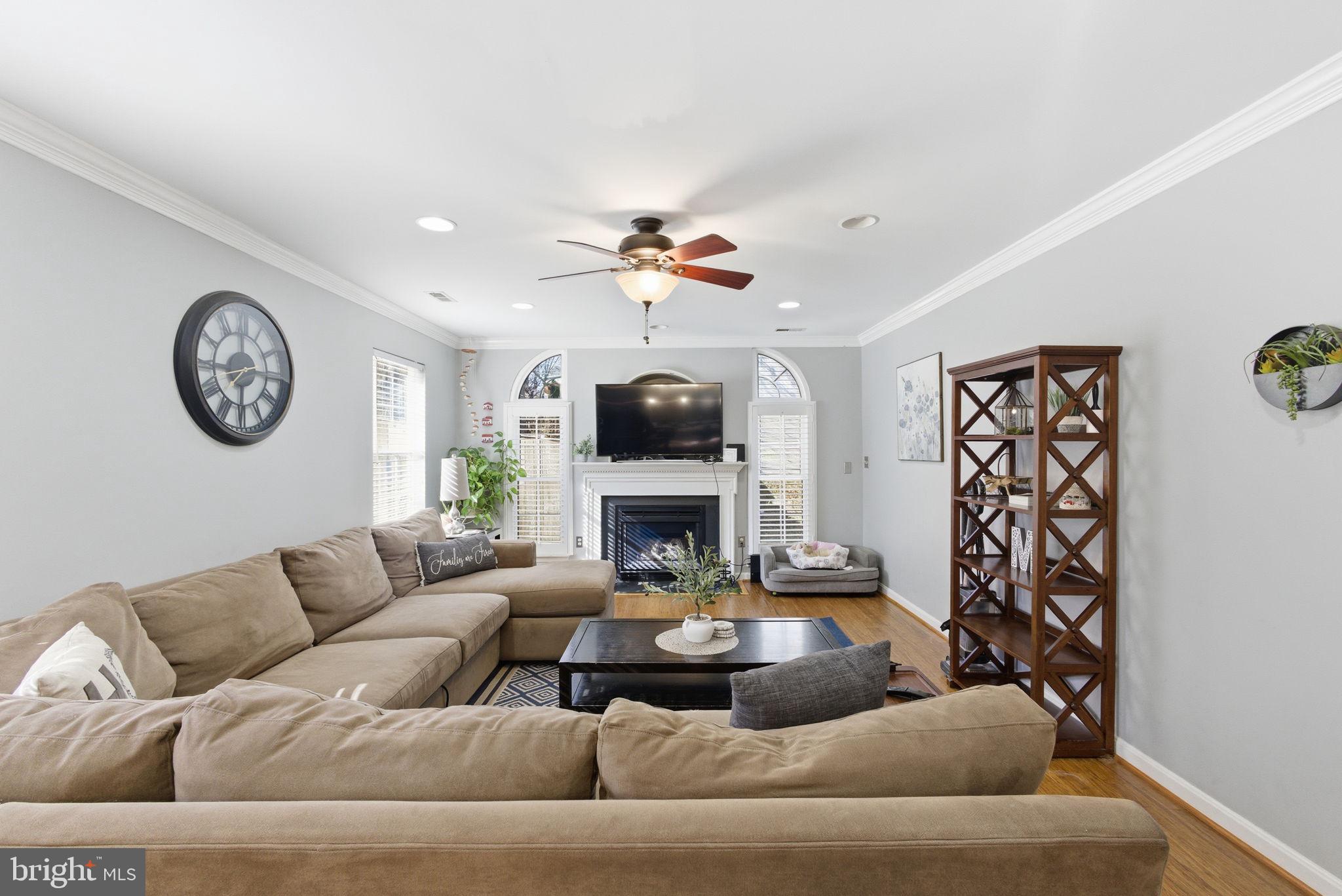 44913 Widgeon Place Callaway, MD 20620 - Photo 21 of 49 a living room with furniture a clock and a fireplace