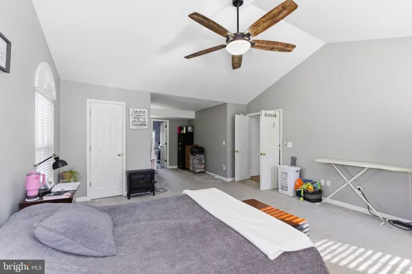 a bed room with a bed and a chandelier