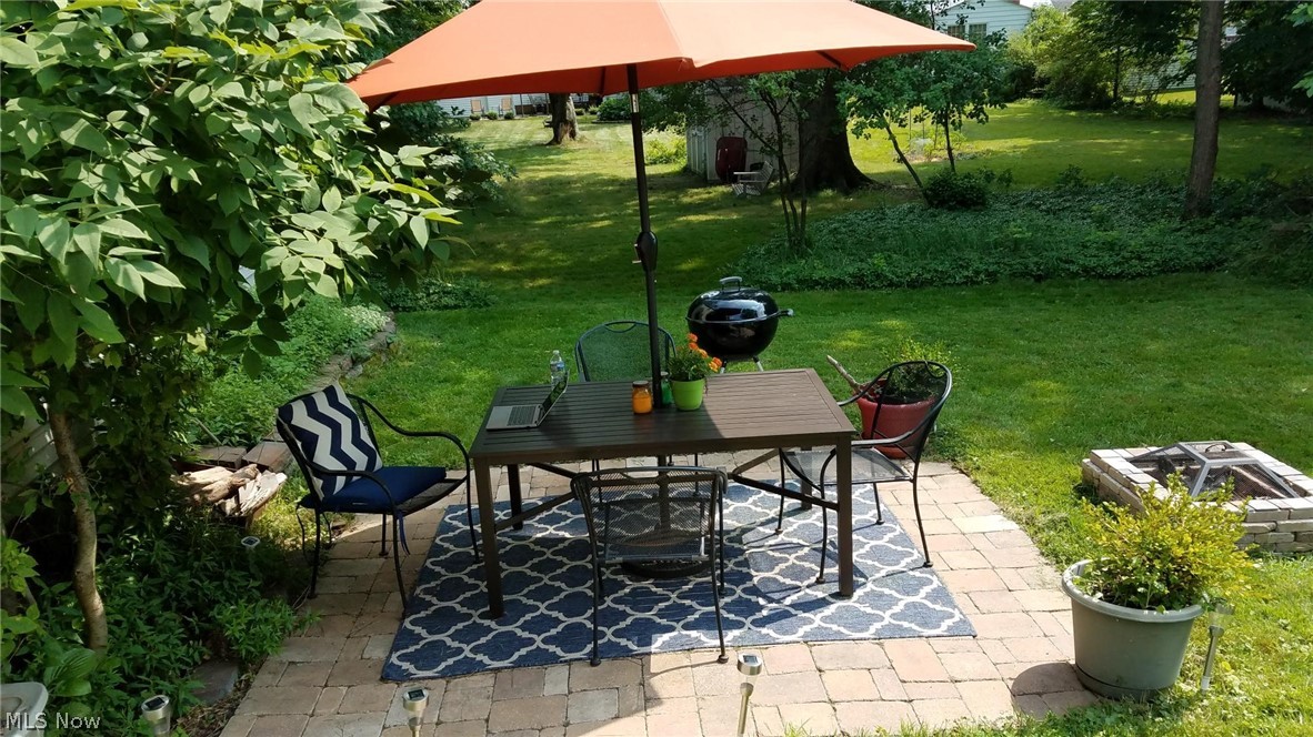 1170 Roland Road Lyndhurst, OH 44124 - Photo 31 of 36 View of patio featuring an outdoor fire pit in the summer