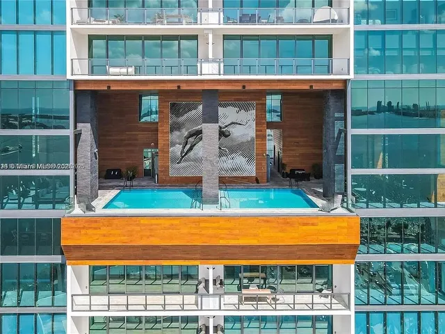 a view of swimming pool with a lounge chairs