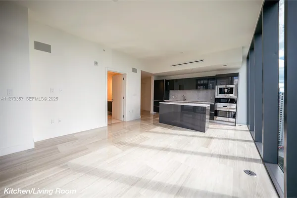 a view of wooden floor and windows in a room