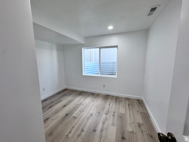 12339 Remy Road, Unit 422 Herriman, UT 84096 - Photo 26 of 36 Unfurnished room featuring light wood finished floors and baseboards