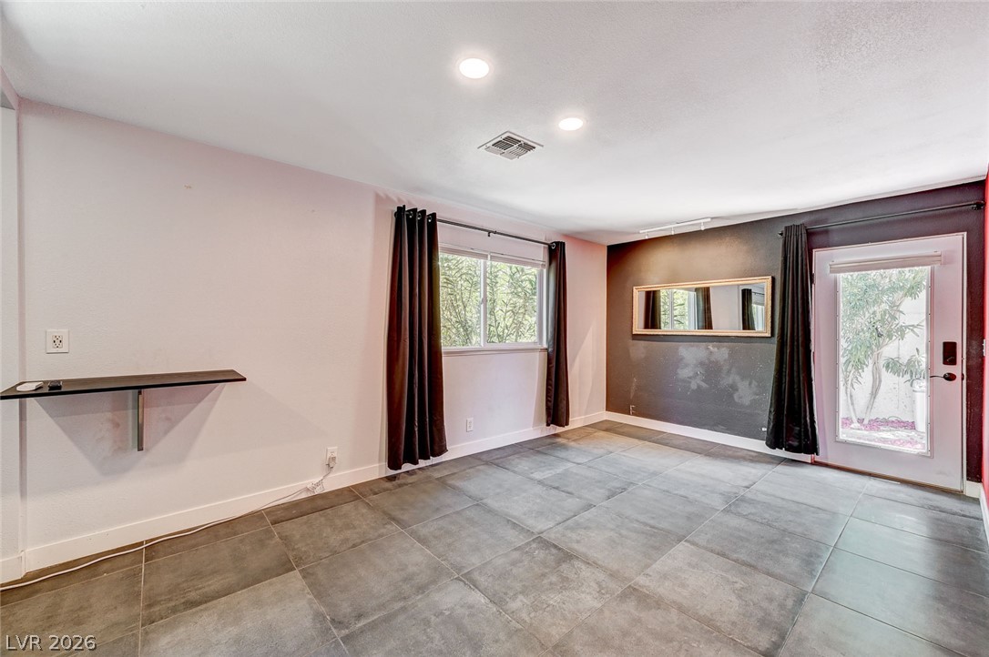 4153 Woodcrest Road Las Vegas, NV 89121 - Photo 37 of 58 Recessed lighting illuminates this versatile space, featuring tiled floors and direct outdoor access.