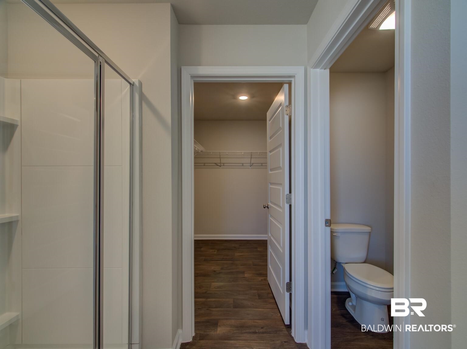23953 Citation Loop Daphne, AL 36526 - Photo 22 of 49 Full bathroom featuring a spacious closet, dark wood-type flooring, a shower stall, and recessed lighting