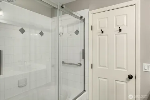 a bathroom with a glass shower door