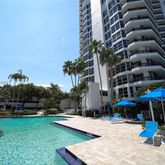 a view of a backyard with swimming pool and furniture