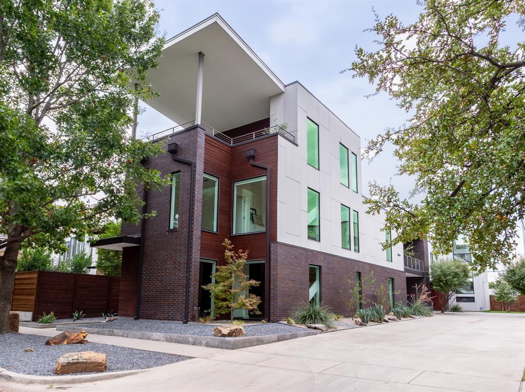 a view of a house with a yard and tree s