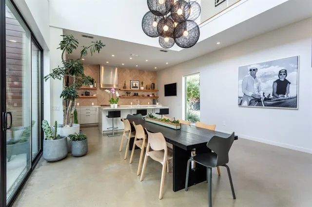 a view of a dining room with furniture and a chandelier