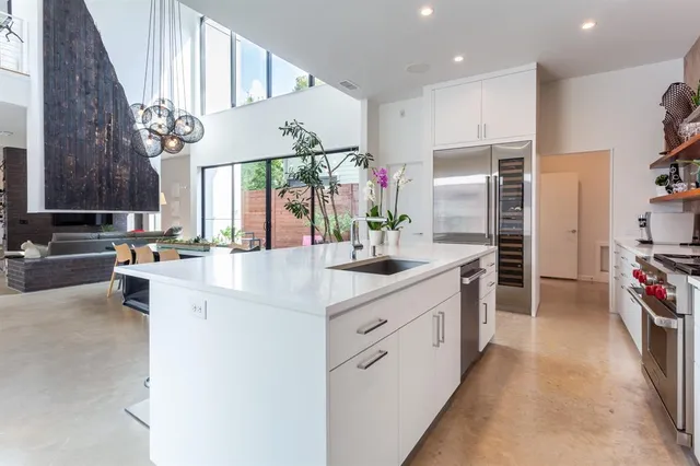 a kitchen with stainless steel appliances a sink stove and cabinets