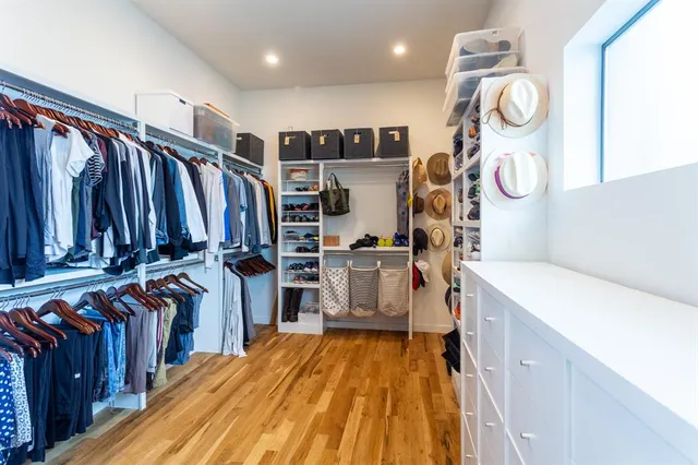 a spacious bedroom with a bed and a window