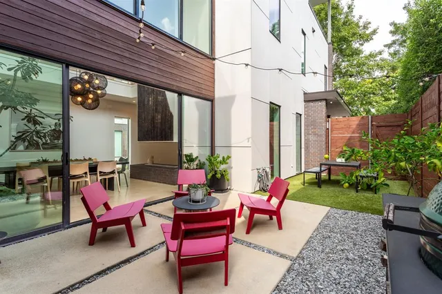 a backyard of a house with outdoor seating