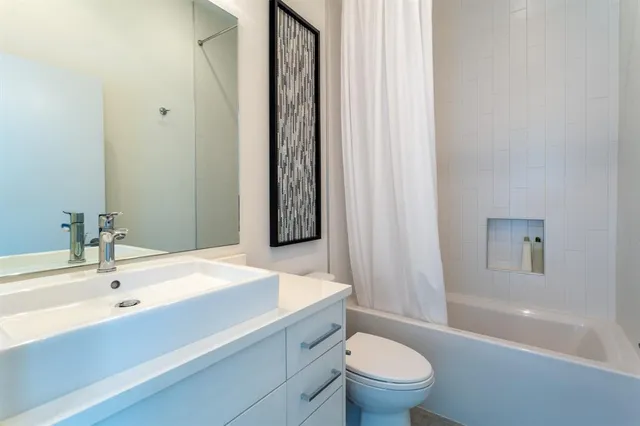 a hallway with a bed and a large window with outer view