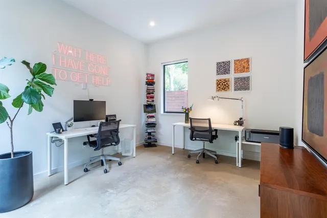 a view of a workspace with furniture and a potted plant