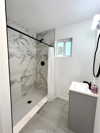 a bathroom with a shower and mirror