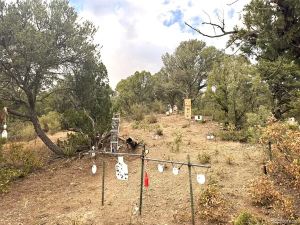 a view of a house with yard and sitting area