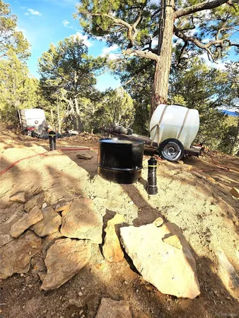 a front view of a house with a yard and hanging chair