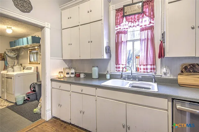 a kitchen with a sink cabinets and window