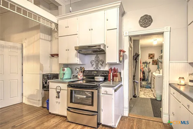 a kitchen with stainless steel appliances a stove and a refrigerator