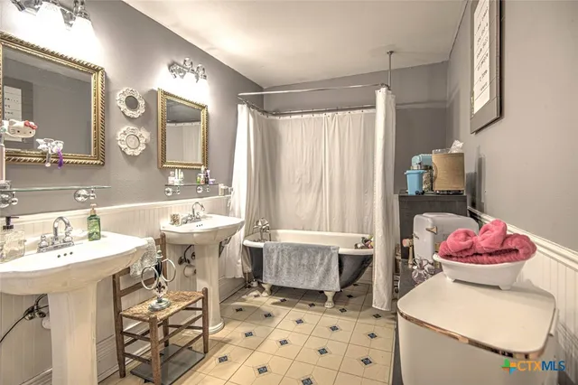 a bathroom with a sink toilet and a mirror