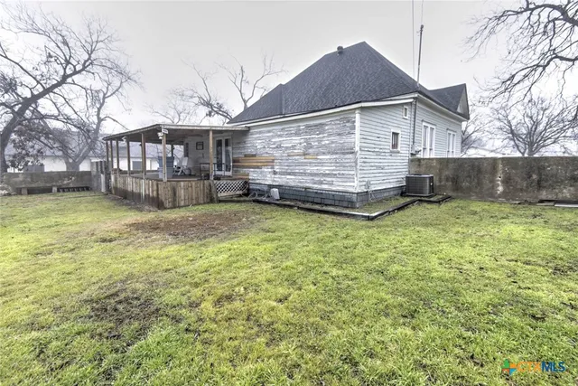 a view of a house with a yard and sitting area